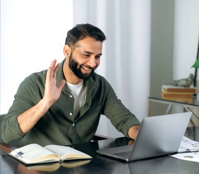 pleasant friendly indian guy manager or financial consultant communicates with colleagues on a.jpg